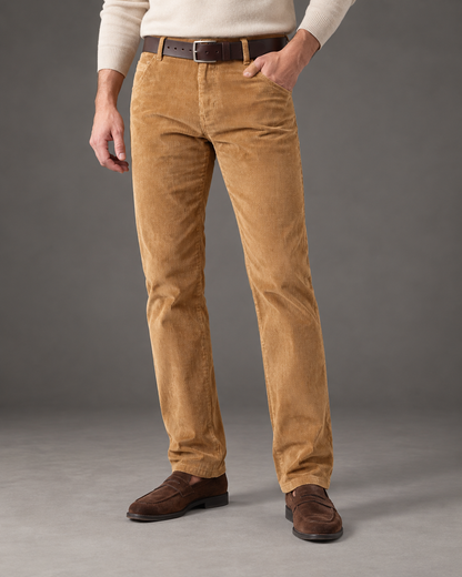 Hollis khaki corduroy trousers worn with an ecru sweater, showing the straight leg from waist to hem